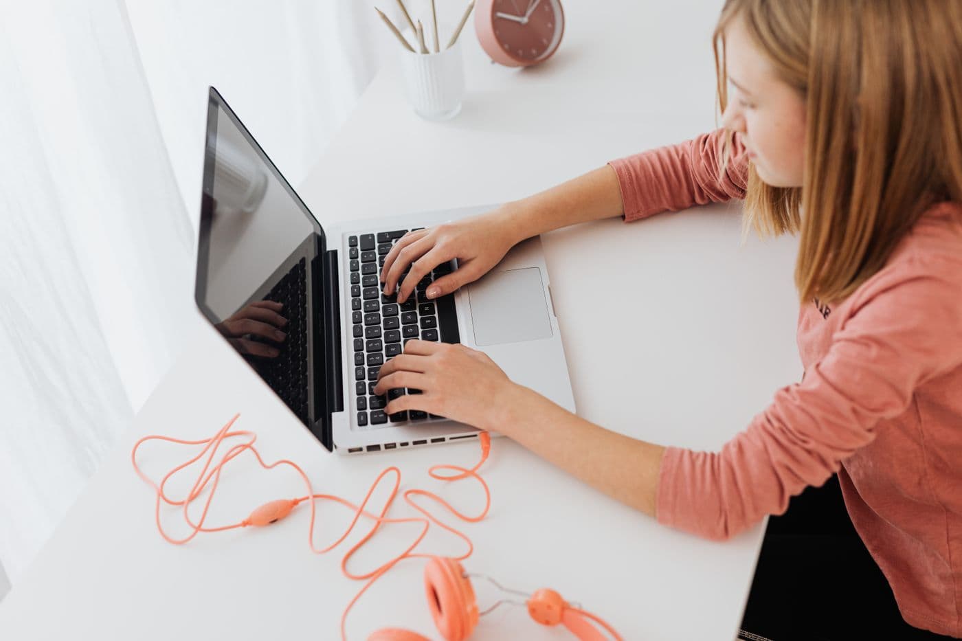 Student with headphones focused on a laptop