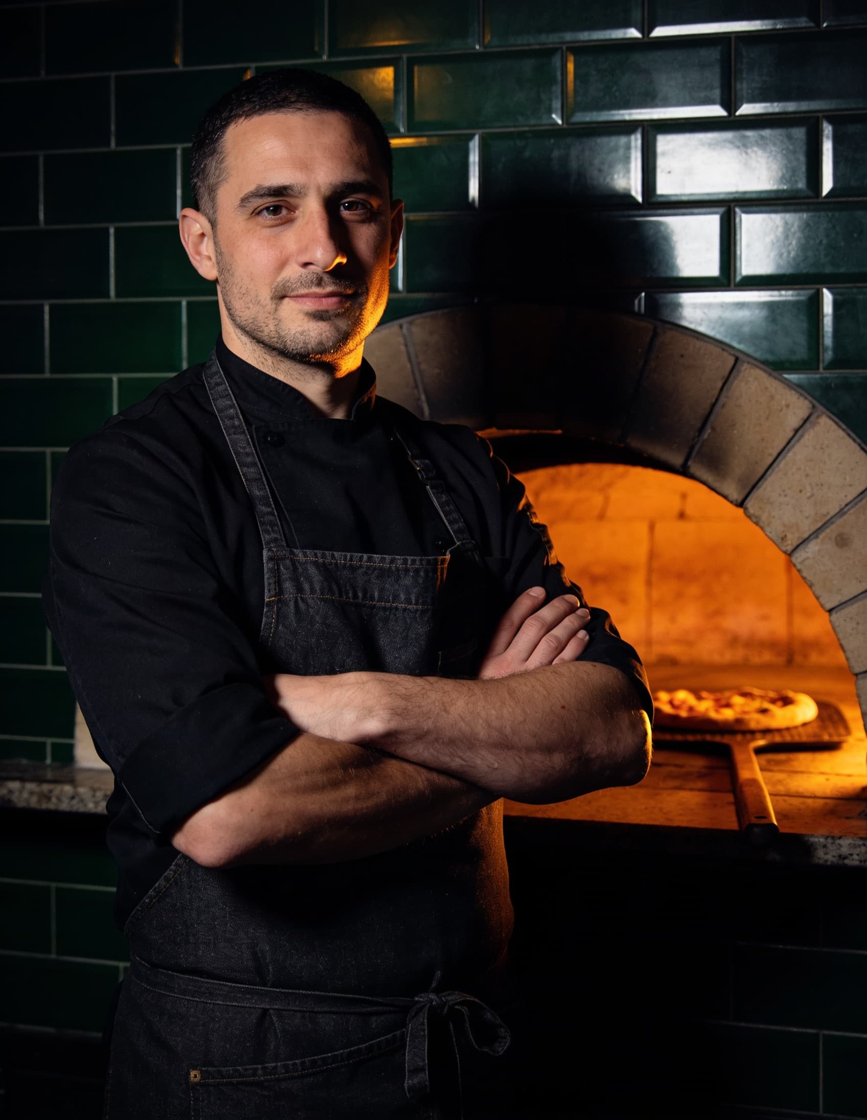 Ember's head chef before the wood-fired oven