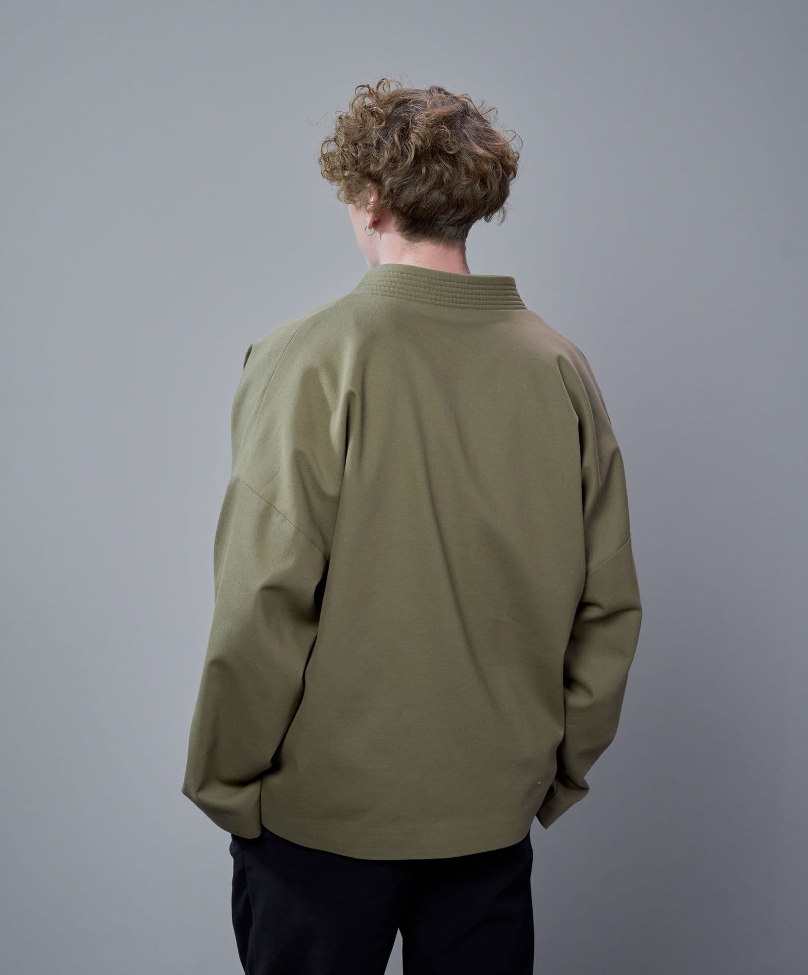 Four pockets, a dry-waxed cotton shell, and a collar that stands on its own.