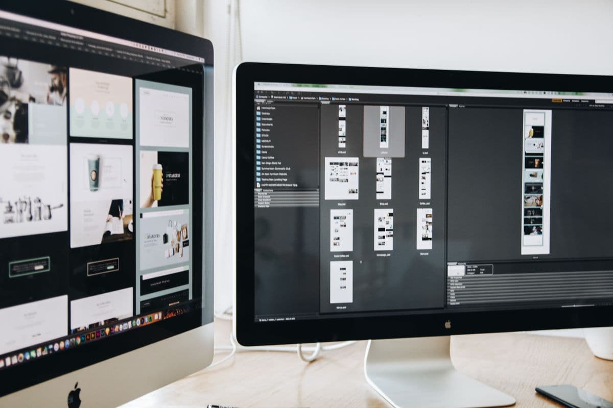 Dual monitors displaying a web design project mid-build