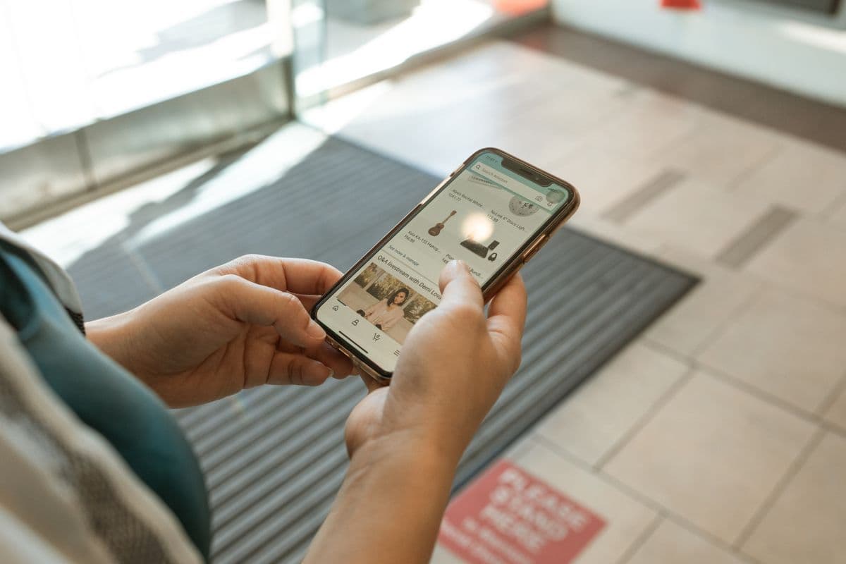 Hands holding a phone with a finished website open on screen
