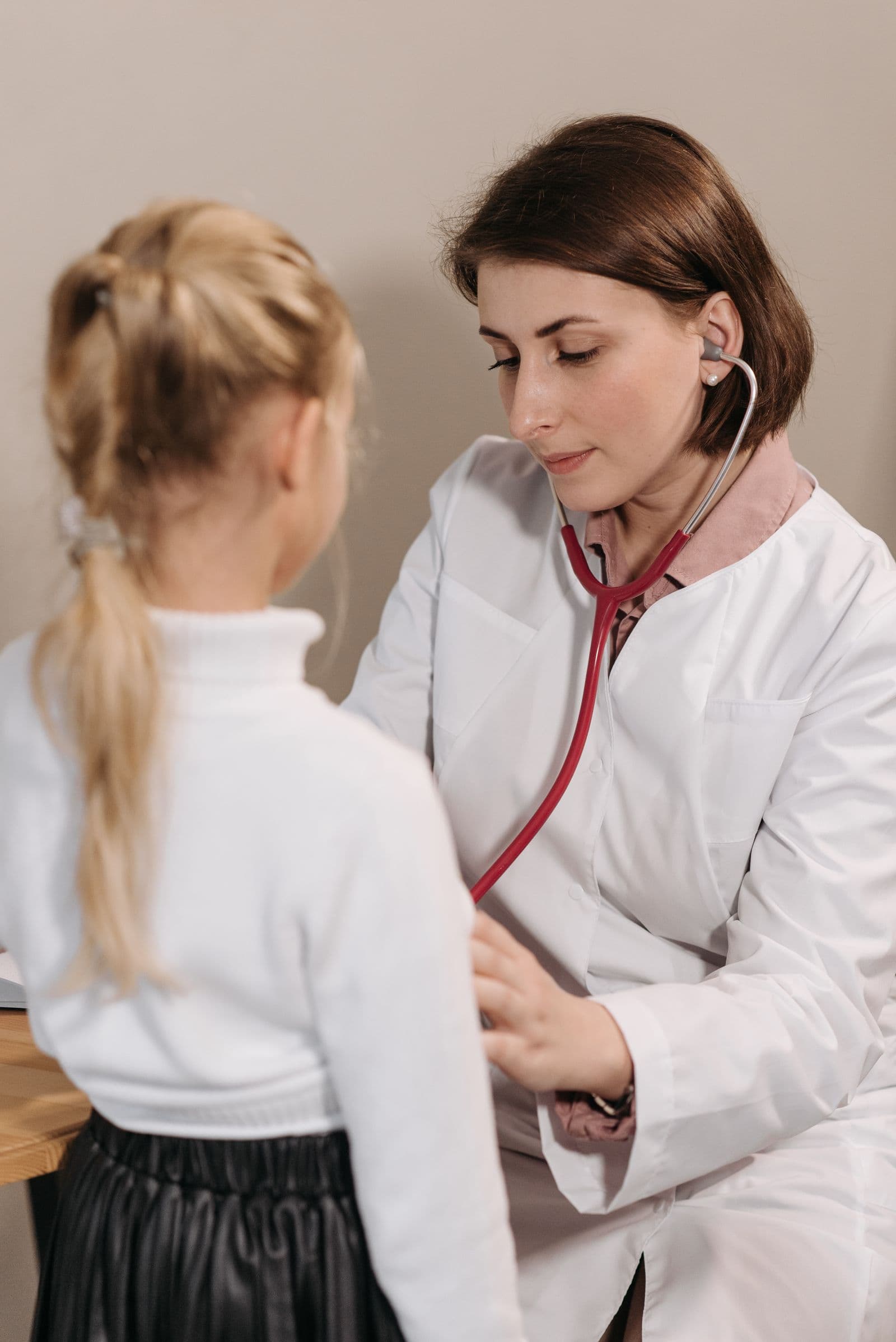 Paediatrician examining a child