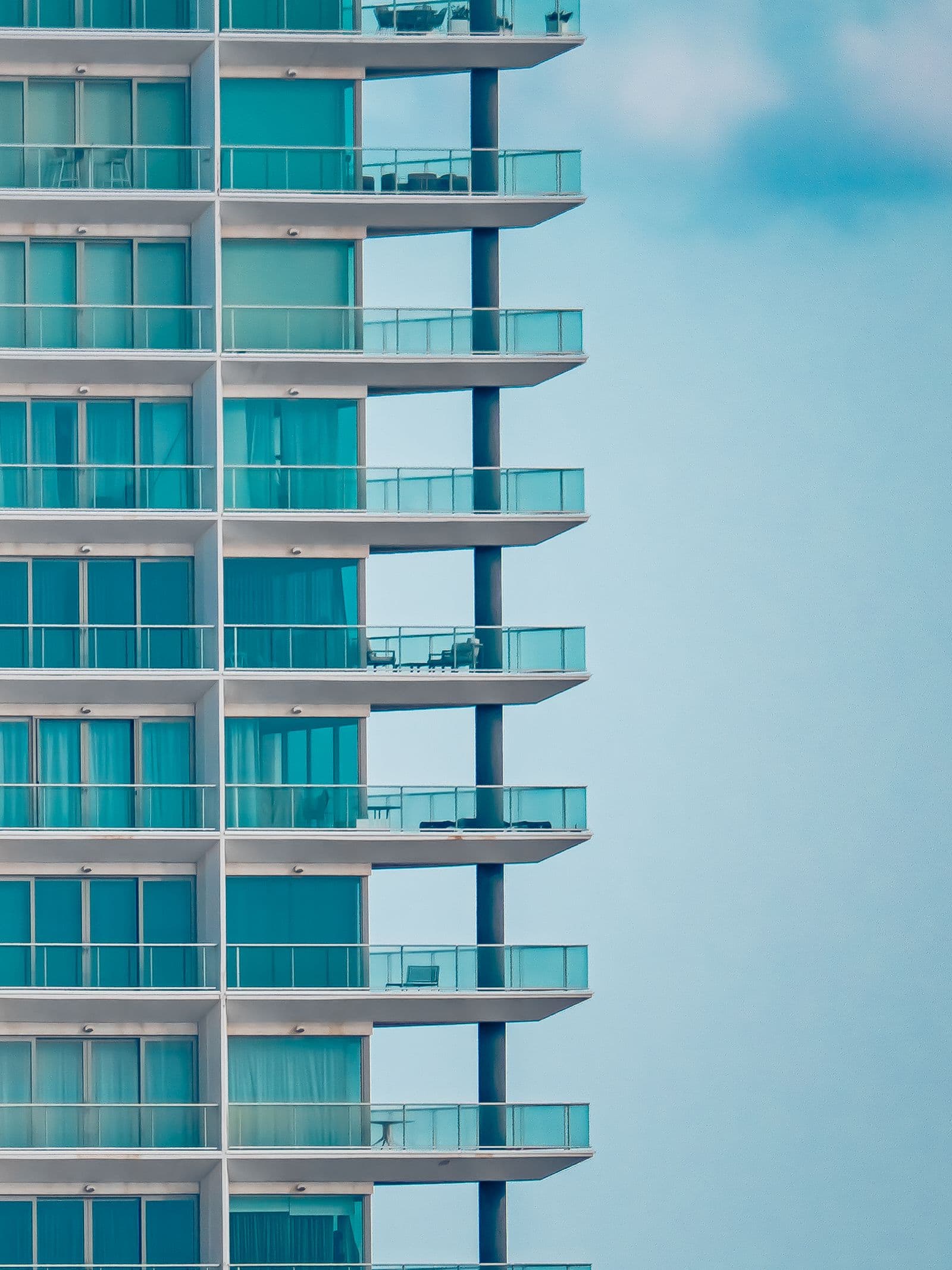 Modern glass residential tower against the sky