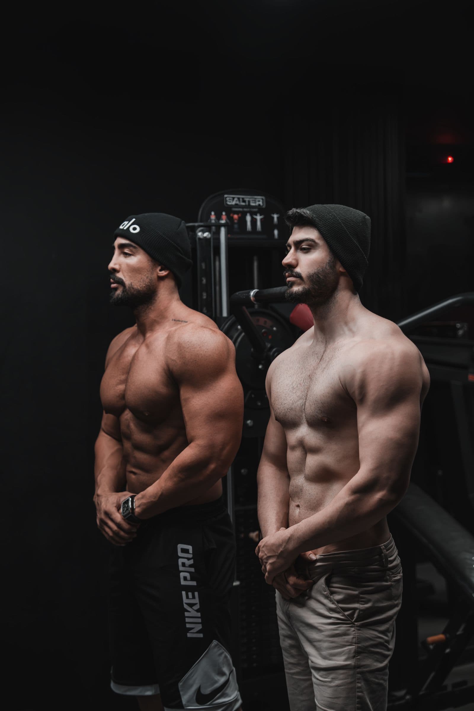 Two athletes in a dim gym