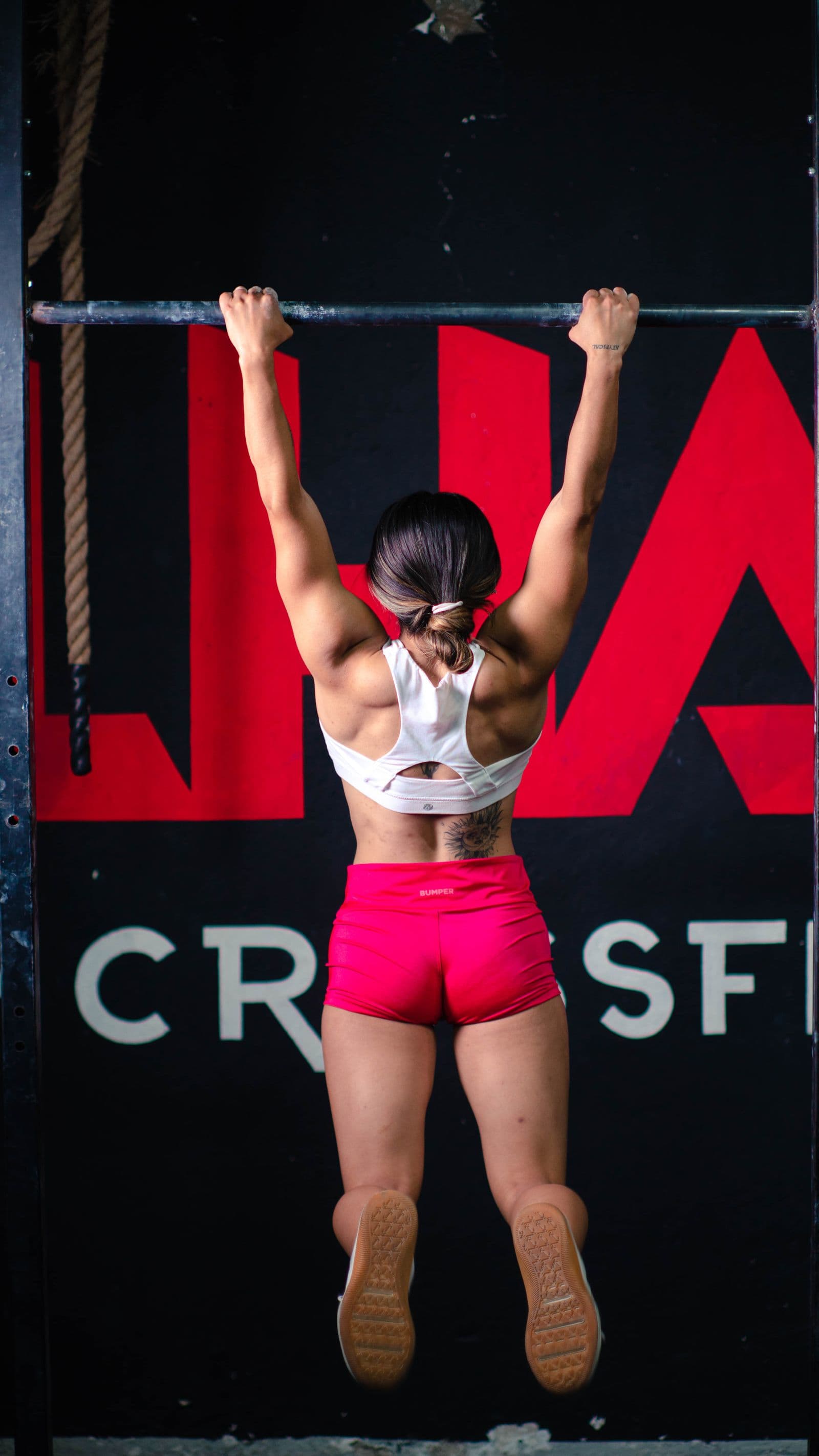 Woman executing a strict pull-up