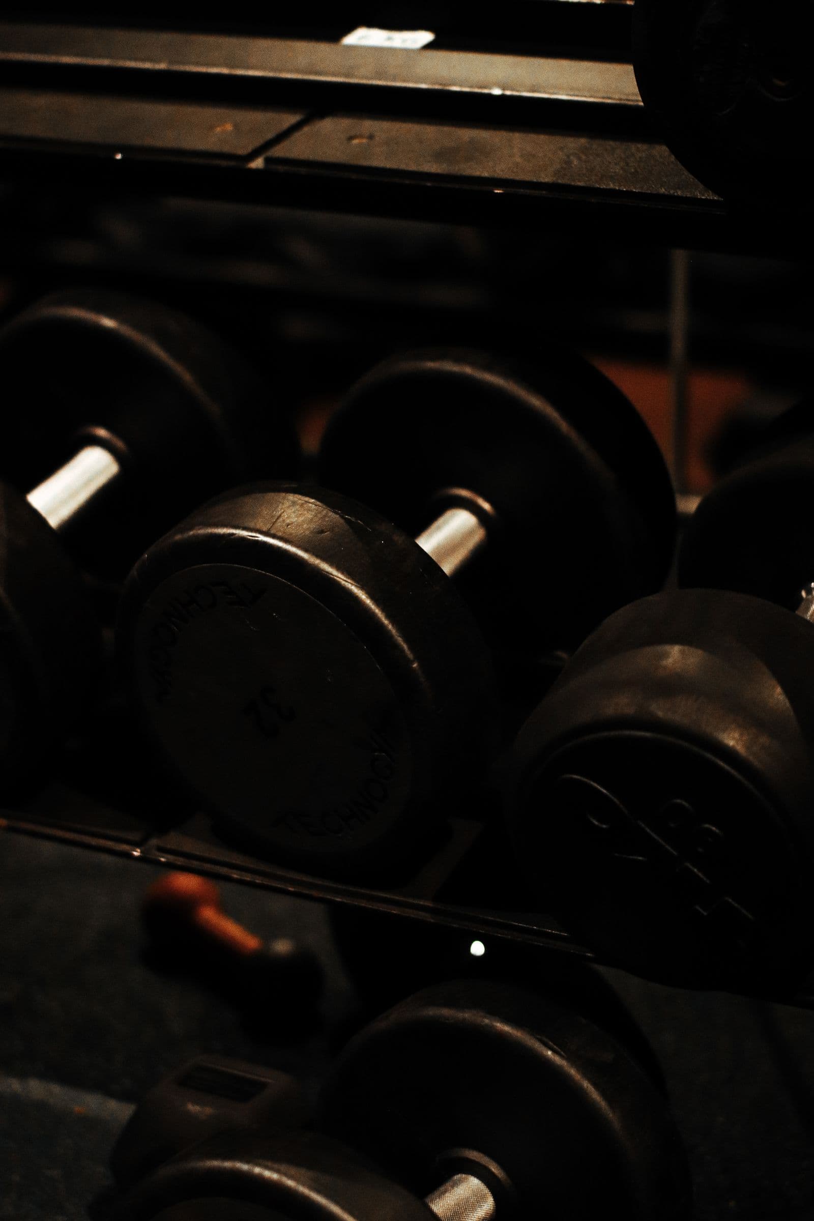 Dumbbell rack in a dim gym