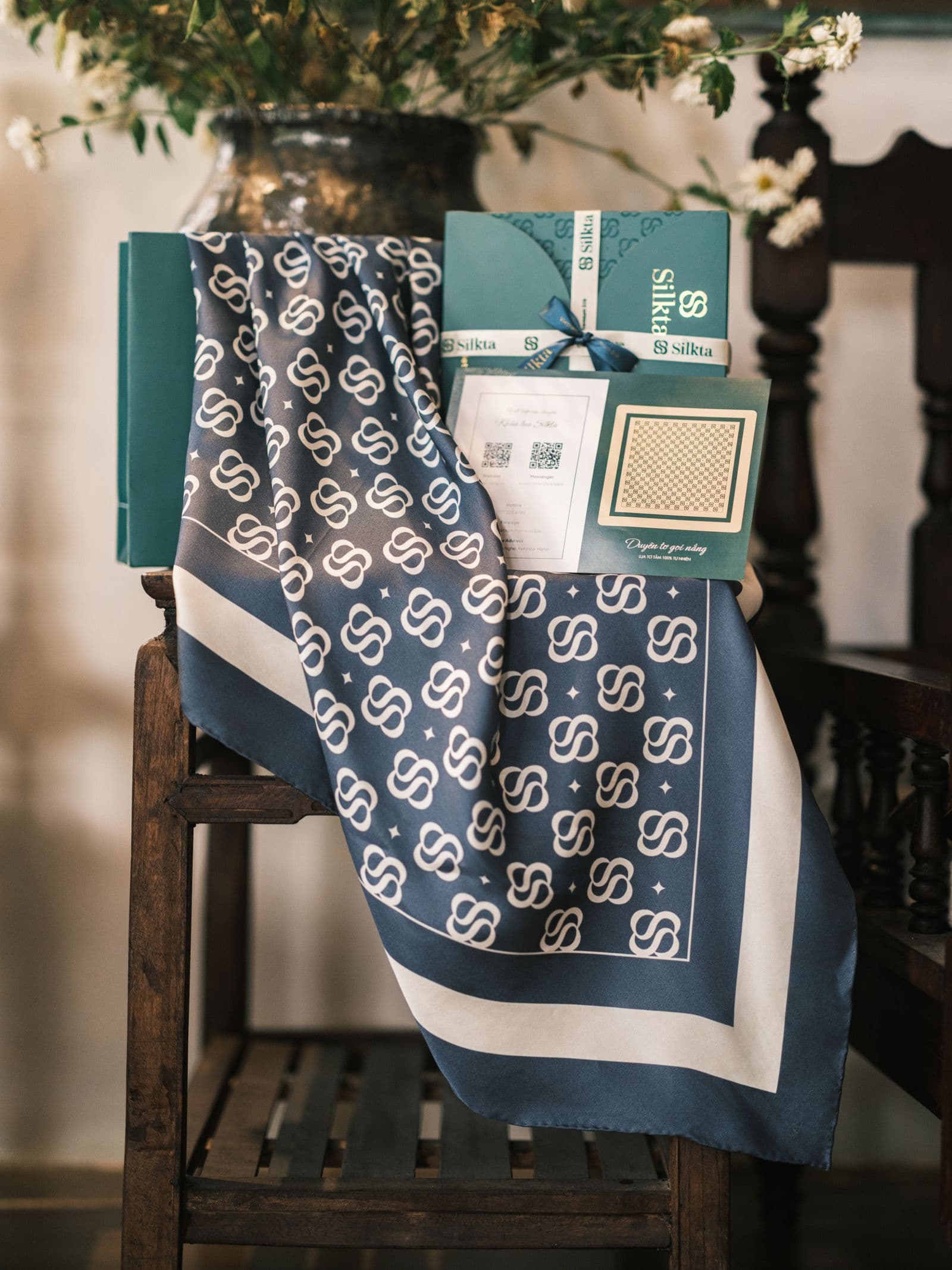 Silk scarf draped over linen